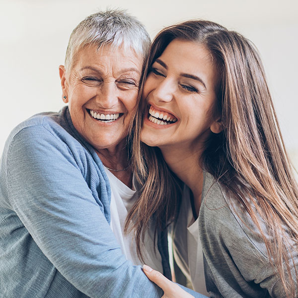 Happy adult mother and daughter embracing